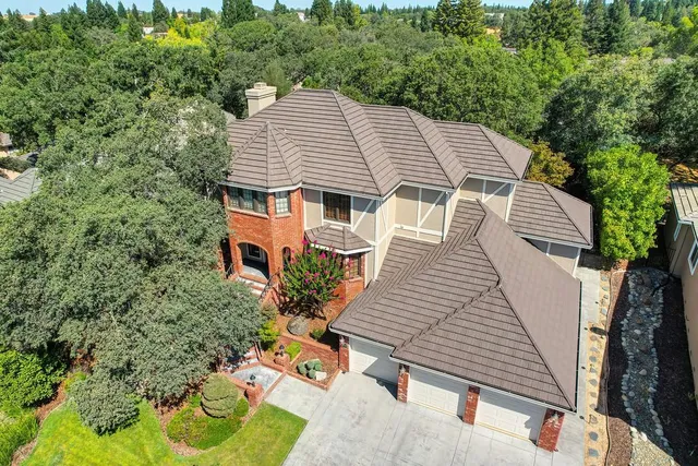 an aerial view of a house with a yard