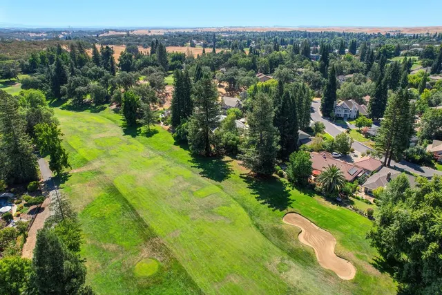 a swimming pool with trees in the background
