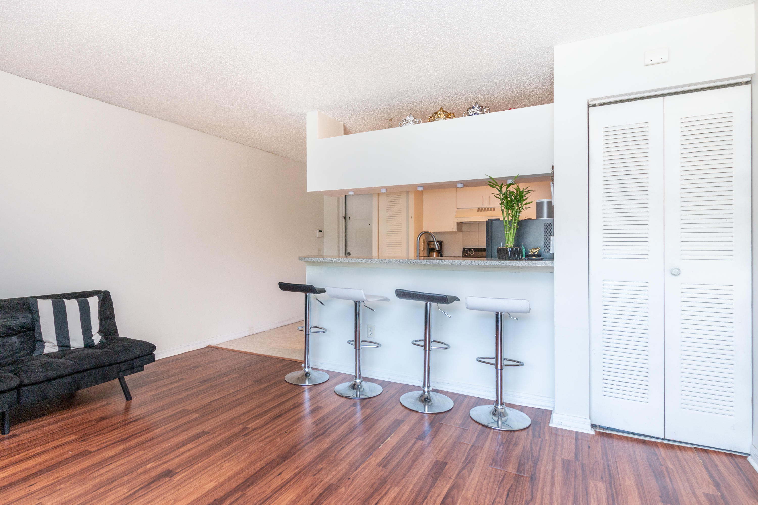 460 South Park Road, Unit 110 Hollywood, FL 33021 - Photo 8 of 17 a kitchen with granite countertop a stove and a wooden floors