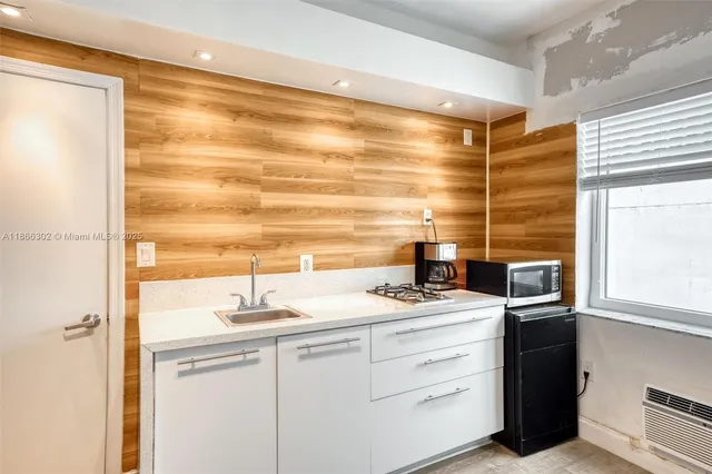 a kitchen with a sink and a refrigerator