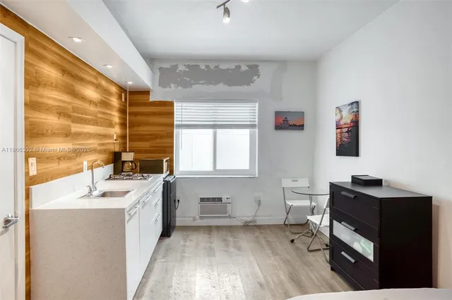 a kitchen with a sink cabinets and a window