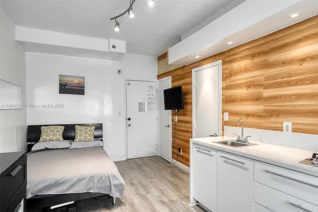 a bedroom with a bed and a flat screen tv