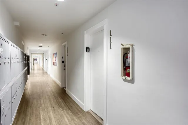 a view of hallway with wooden floor