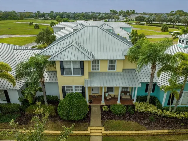 a aerial view of a house with a yard and a swimming pool