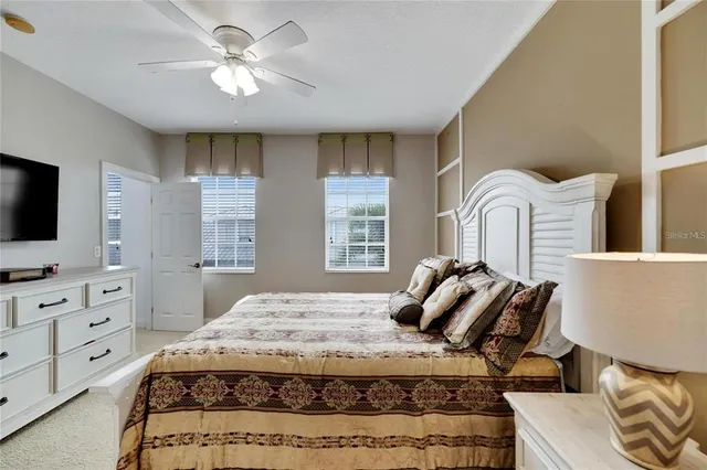 a bedroom with a bed and flat screen tv