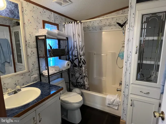 a view of a balcony with wooden floor and outdoor seating