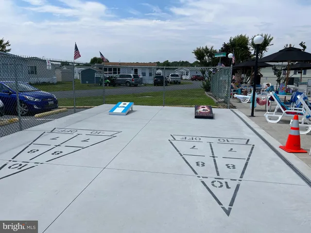 a view of backyard with swimming pool and seating space