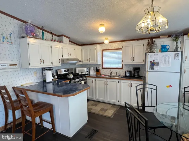 a view of a room with furniture and wooden floor