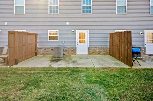 a view of a backyard with a door and chair