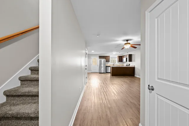 a view of a living room with furniture and wooden floor