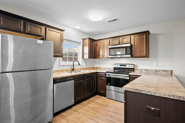 a kitchen with a refrigerator sink and microwave