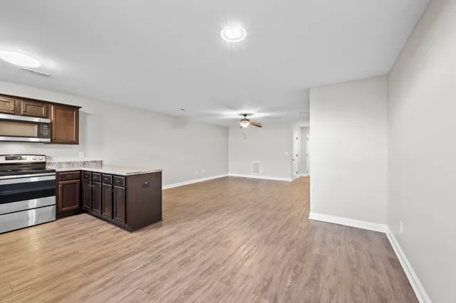 a kitchen with wooden floors and wooden cabinets