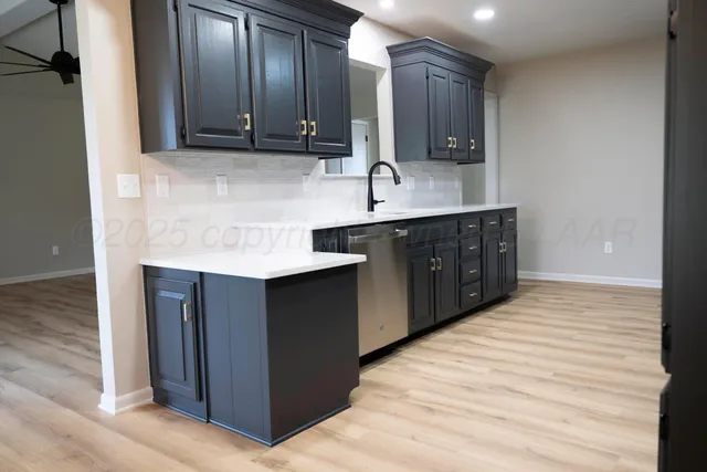 a kitchen with stainless steel appliances granite countertop a sink and cabinets