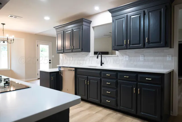 a kitchen with a sink and a refrigerator