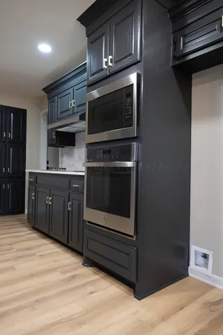 a kitchen with stainless steel appliances granite countertop a stove and a microwave