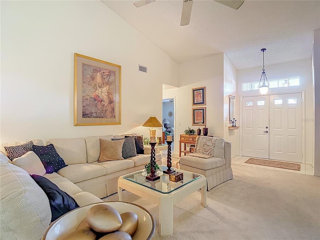 2337 Hidden Trail Drive Spring Hill, FL 34606 - Photo 5 of 24 a living room with furniture and a chandelier