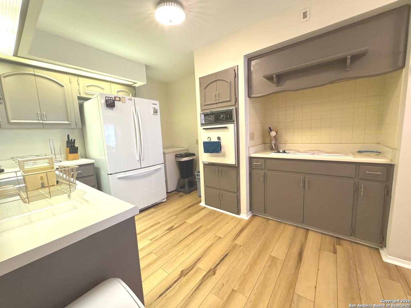 7500 Callaghan, Unit 254 San Antonio, TX 78229 - Photo 21 of 36 a kitchen with a sink appliances and cabinets