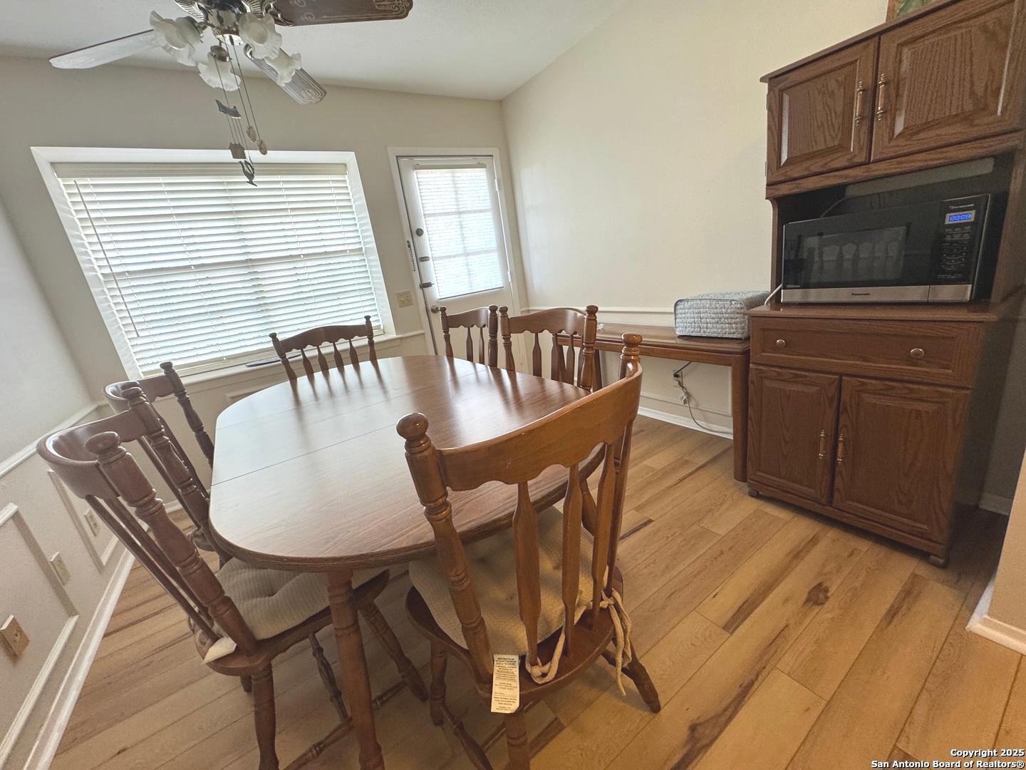 7500 Callaghan, Unit 254 San Antonio, TX 78229 - Photo 23 of 36 a view of a dining room with furniture window and wooden floor