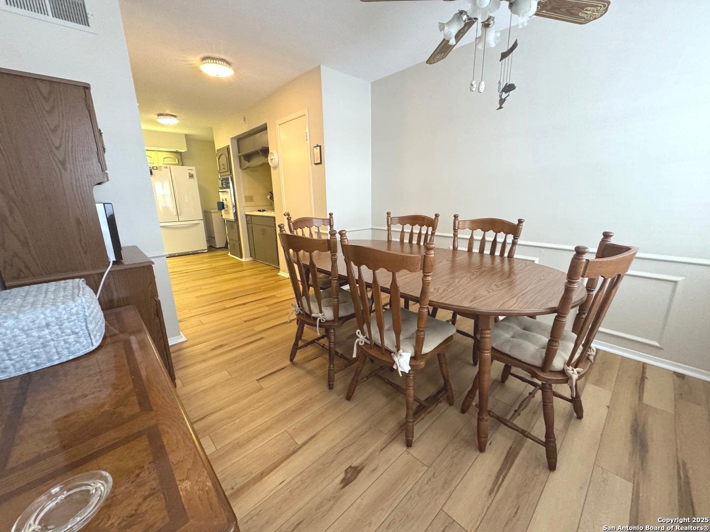 7500 Callaghan, Unit 254 San Antonio, TX 78229 - Photo 24 of 36 a view of a dining room with furniture and wooden floor