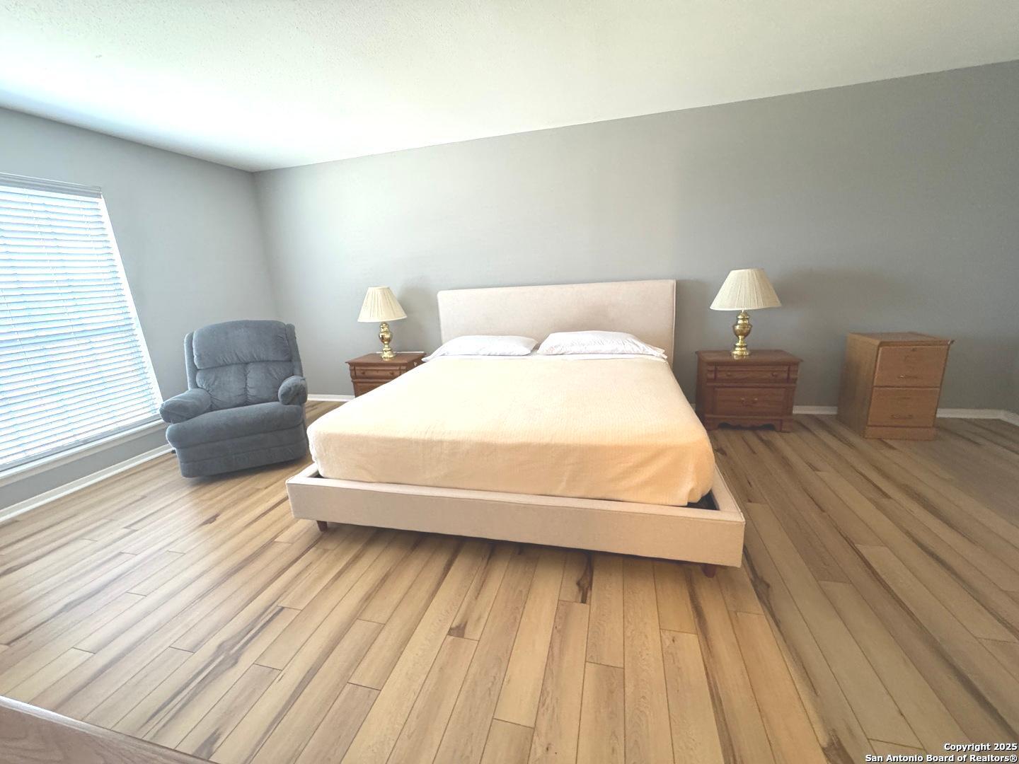 7500 Callaghan, Unit 254 San Antonio, TX 78229 - Photo 27 of 36 a bedroom with a bed and a night stand