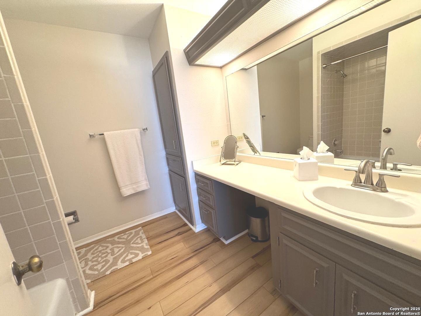 7500 Callaghan, Unit 254 San Antonio, TX 78229 - Photo 32 of 36 a bathroom with a sink and a mirror