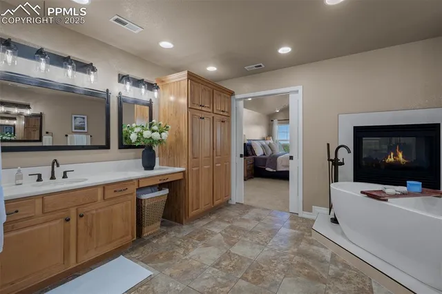 a bathroom with a granite countertop sink toilet and a mirror