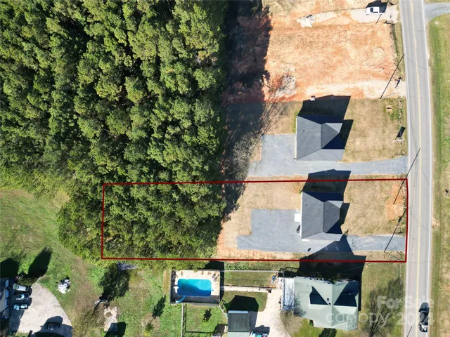 an aerial view of house with yard