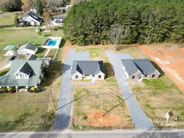 an aerial view of a house with outdoor space