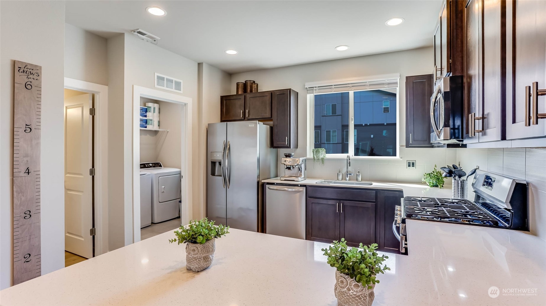 3517 193rd Street Southeast, Unit F Bothell, WA 98012 - Photo 11 of 33 a kitchen with stainless steel appliances granite countertop a refrigerator and a sink