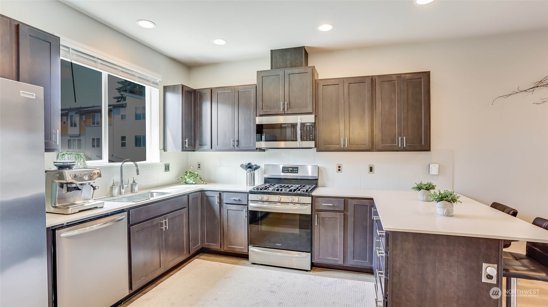 3517 193rd Street Southeast, Unit F Bothell, WA 98012 - Photo 12 of 33 a kitchen with a sink stove and microwave