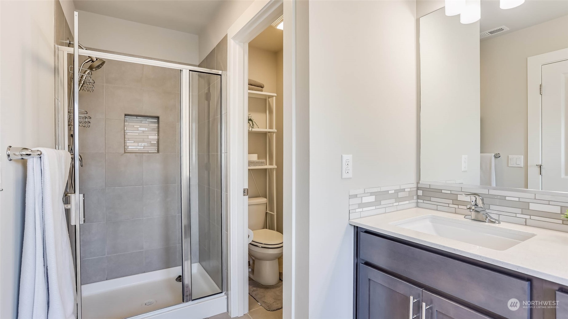 3517 193rd Street Southeast, Unit F Bothell, WA 98012 - Photo 20 of 33 a bathroom with a shower sink vanity and mirror