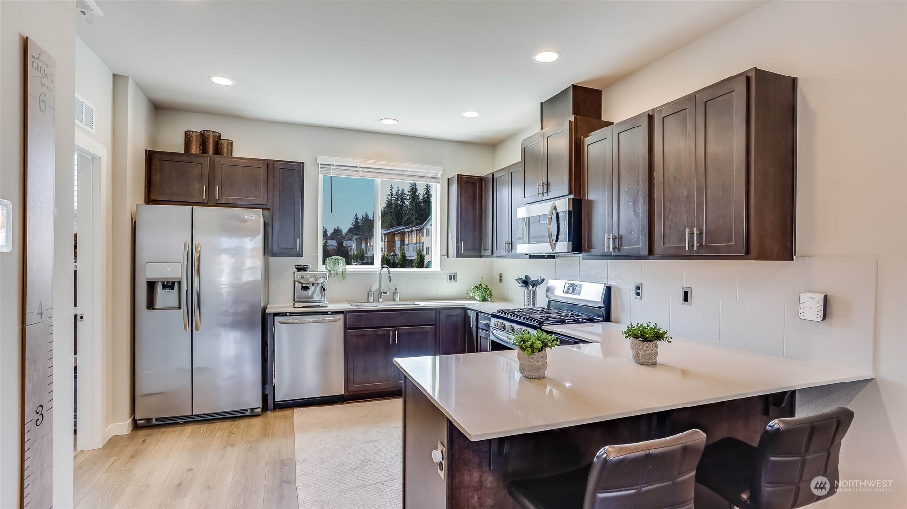 3517 193rd Street Southeast, Unit F Bothell, WA 98012 - Photo 10 of 33 a kitchen with stainless steel appliances a sink stove and refrigerator