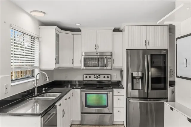 a kitchen with a sink stove and refrigerator