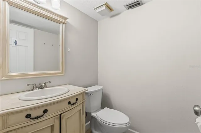 a bathroom with a sink toilet and mirror
