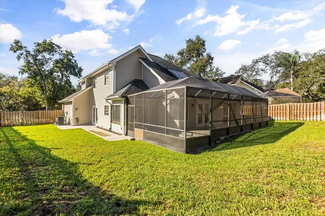 a view of a house with a yard and sitting area