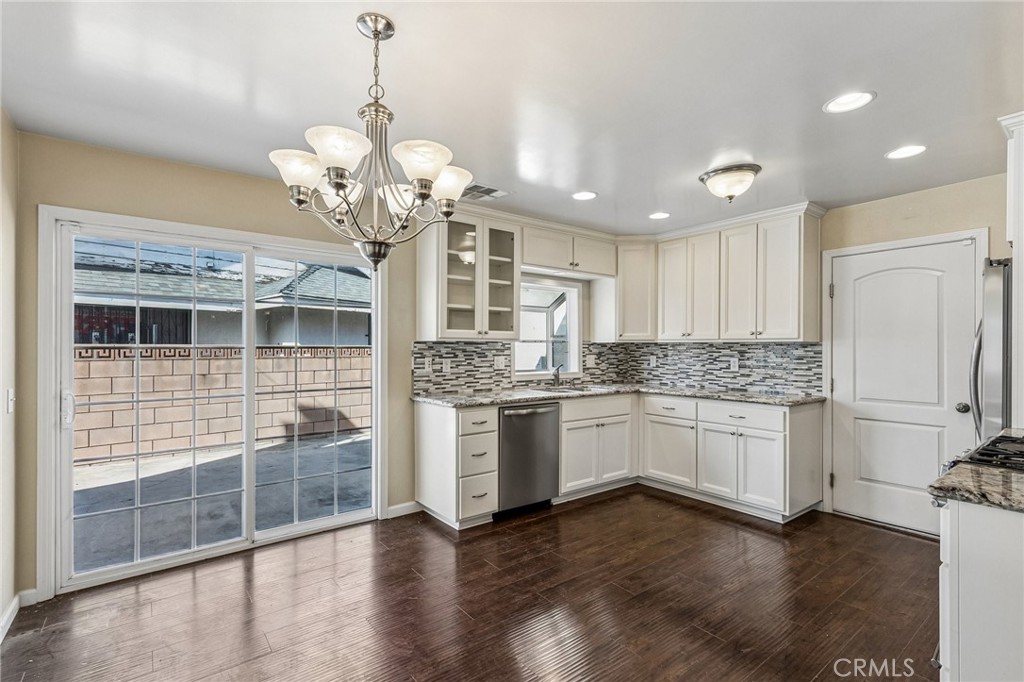 486 South Rall Avenue La Puente, CA 91746 - Photo 11 of 42 a kitchen with stainless steel appliances granite countertop a granite counter tops and a wooden floor