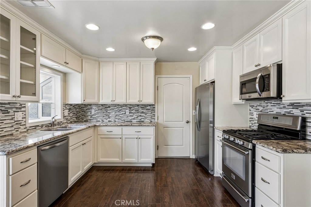 486 South Rall Avenue La Puente, CA 91746 - Photo 14 of 42 a kitchen with granite countertop a sink stainless steel appliances and cabinets