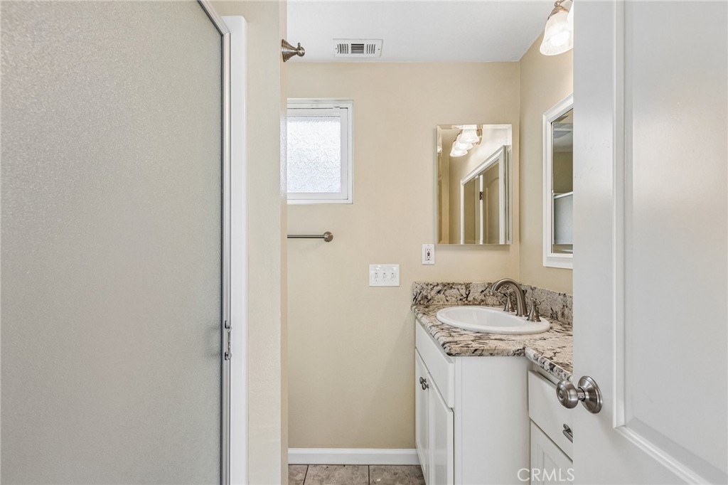 486 South Rall Avenue La Puente, CA 91746 - Photo 34 of 42 a bathroom with a sink and a mirror