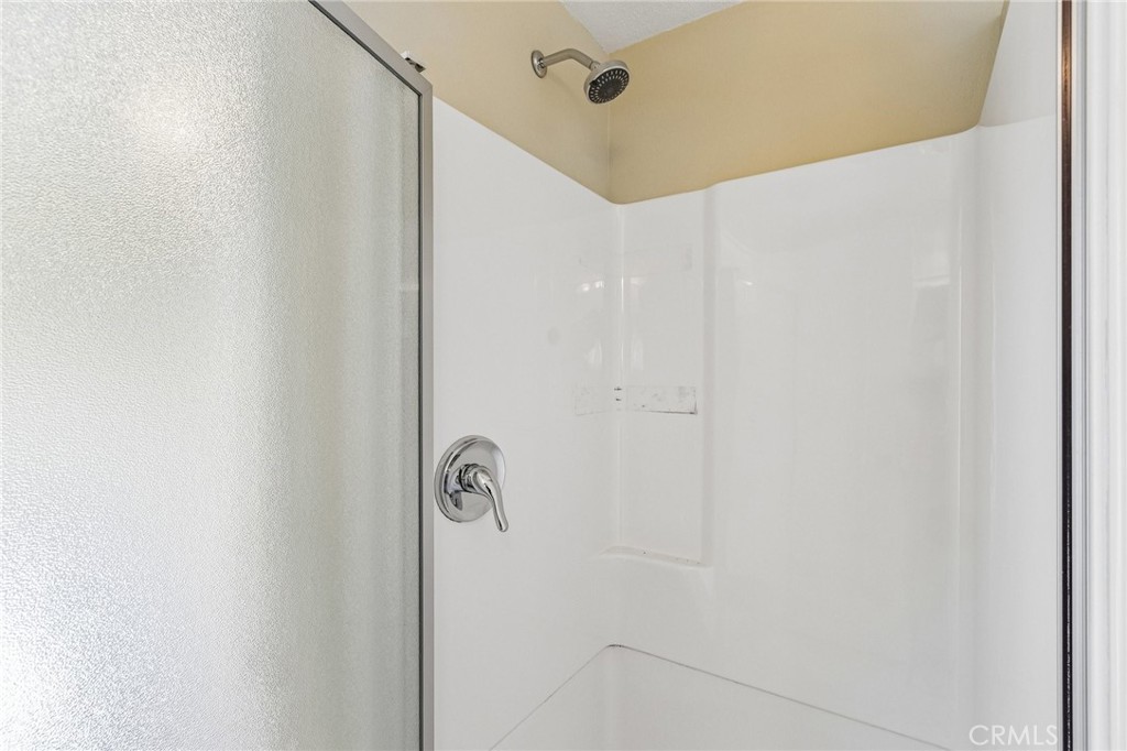 486 South Rall Avenue La Puente, CA 91746 - Photo 36 of 42 a bathroom with a shower and a mirror