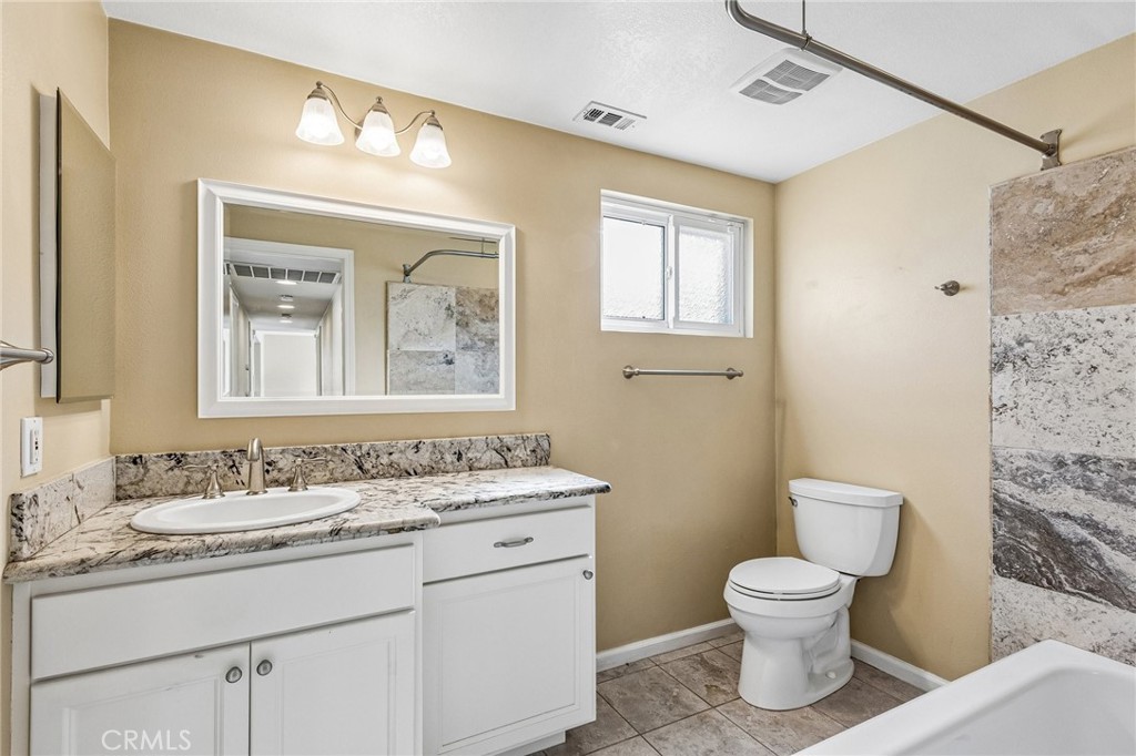 486 South Rall Avenue La Puente, CA 91746 - Photo 37 of 42 a bathroom with a toilet sink and mirror