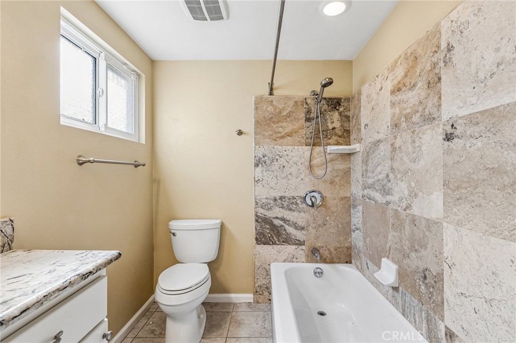 486 South Rall Avenue La Puente, CA 91746 - Photo 38 of 42 a bathroom with a granite countertop sink a toilet and shower