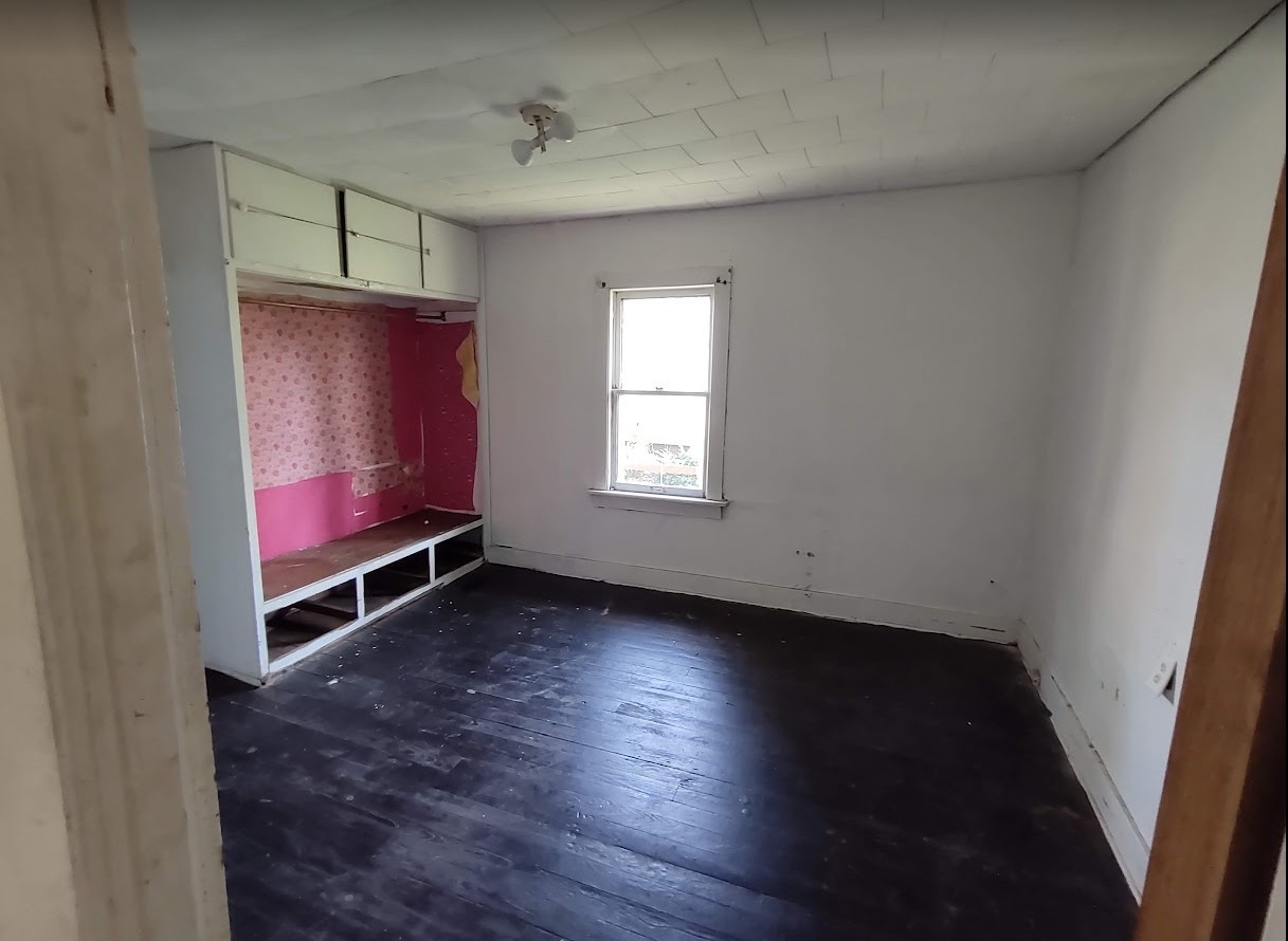 329 Albert Boulevard Kankakee, IL 60901 - Photo 4 of 12 an empty room with wooden floor and windows