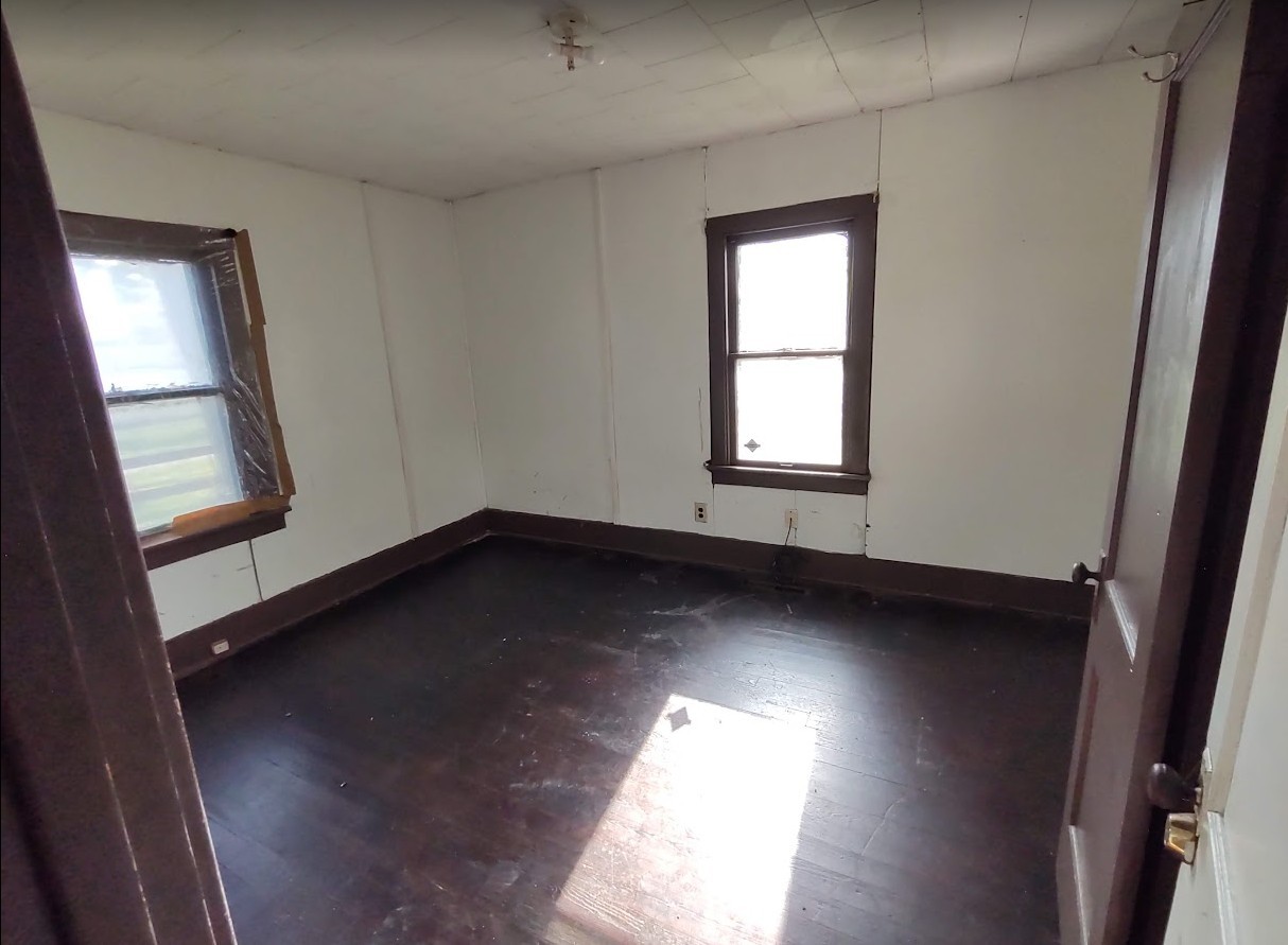 329 Albert Boulevard Kankakee, IL 60901 - Photo 5 of 12 an empty room with wooden floor and windows