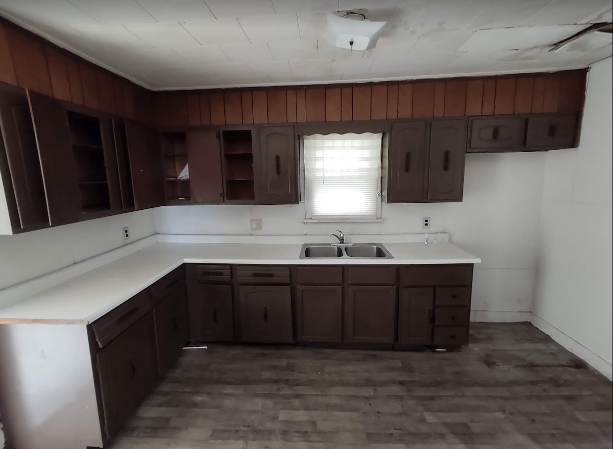 329 Albert Boulevard Kankakee, IL 60901 - Photo 6 of 12 a kitchen with granite countertop a sink cabinets and wooden floor