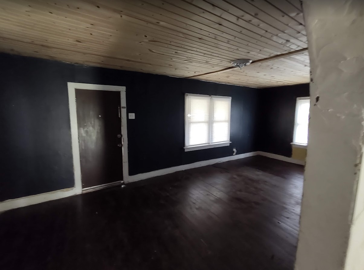 329 Albert Boulevard Kankakee, IL 60901 - Photo 7 of 12 an empty room with wooden floor and windows
