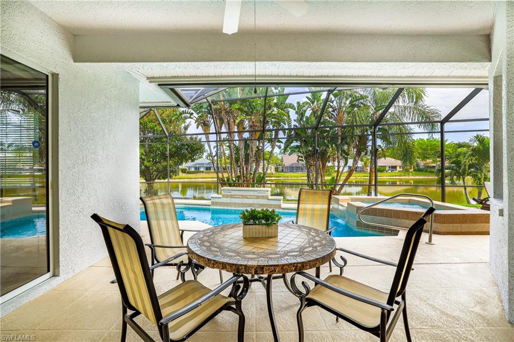 5235 Malvern Court Naples, FL 34112 - Photo 25 of 28 a view of a dining room with a table and chairs