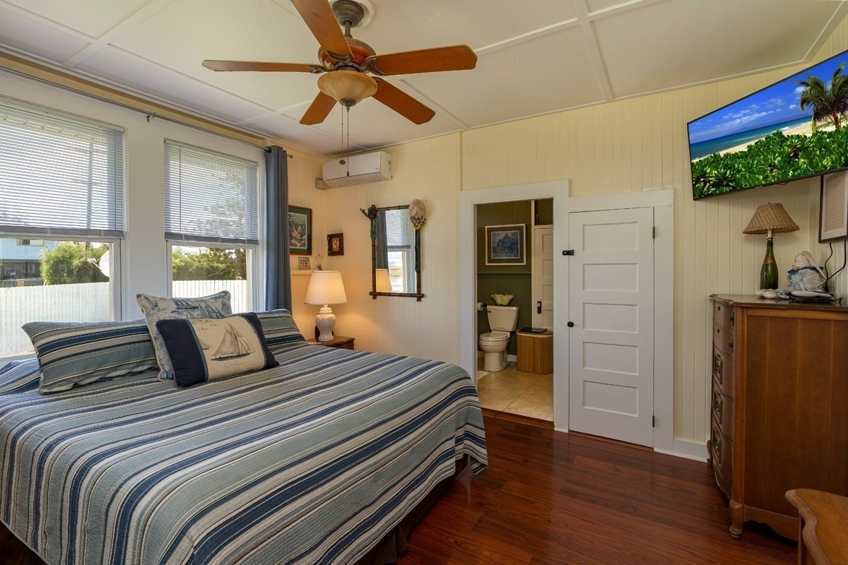 8706 Kiowea Road Kekaha, HI 96752 - Photo 12 of 30 a bedroom with a large bed and a flat tv screen