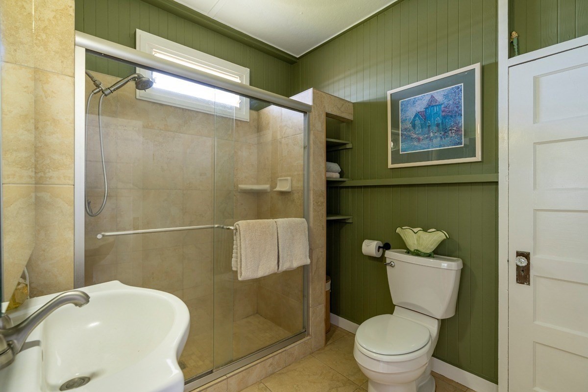 8706 Kiowea Road Kekaha, HI 96752 - Photo 13 of 30 a white toilet sitting next to a bathroom sink and a shower