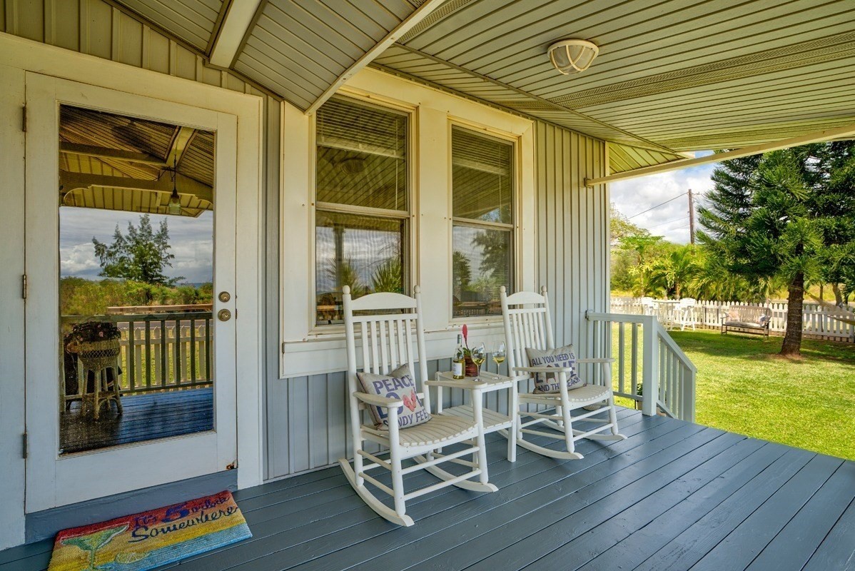 8706 Kiowea Road Kekaha, HI 96752 - Photo 2 of 30 a porch area with wooden floor and outdoor seating