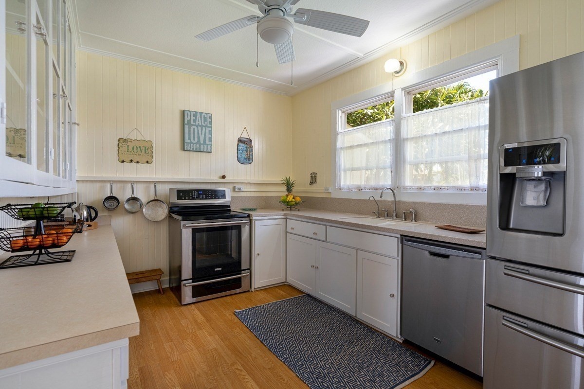 8706 Kiowea Road Kekaha, HI 96752 - Photo 5 of 30 a kitchen with stainless steel appliances a stove a sink and a refrigerator